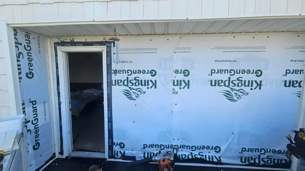 siding contractor Virginia Beach installing weather barrier behind new siding on coastal home