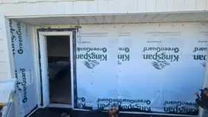 siding contractor Virginia Beach installing weather barrier behind new siding on coastal home