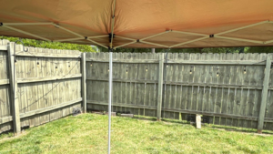 Privacy fence replacement Virginia Beach VA showing aging fence panels and leaning posts near a coastal home