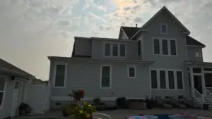 Professional siding material comparison showing vinyl, fiber cement, engineered wood, and composite siding on a residential home