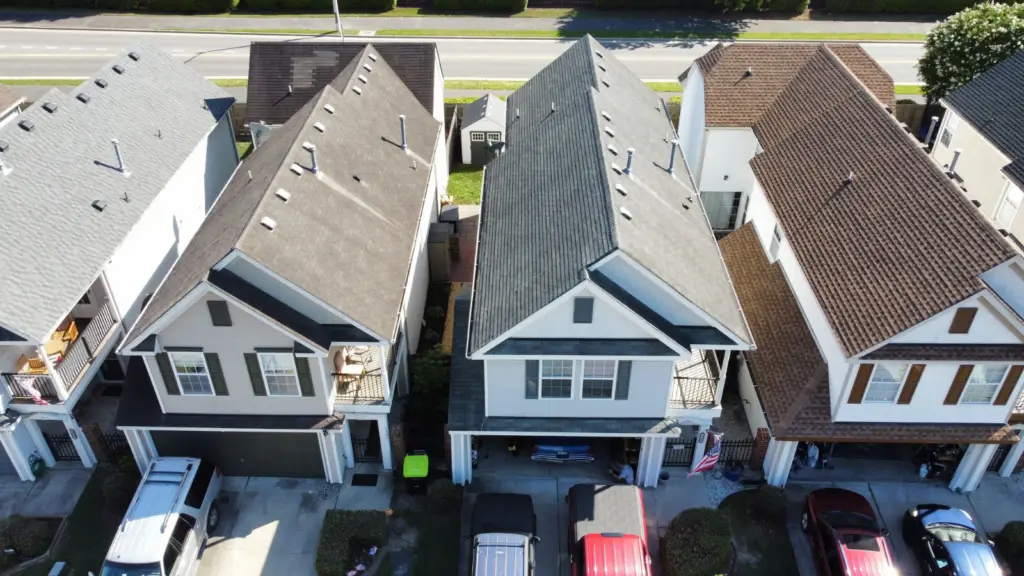Drone performing an aerial roof inspection to identify hidden roof damage before purchasing a home