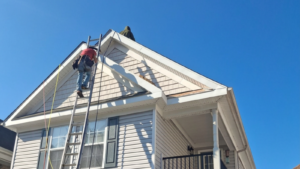 Professional roof inspection Virginia Beach showing a roofing expert inspecting shingles and flashing on a coastal home