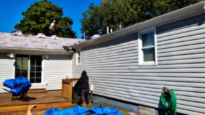 Roof replacement protection Virginia showing professionals protecting a home during roof installation